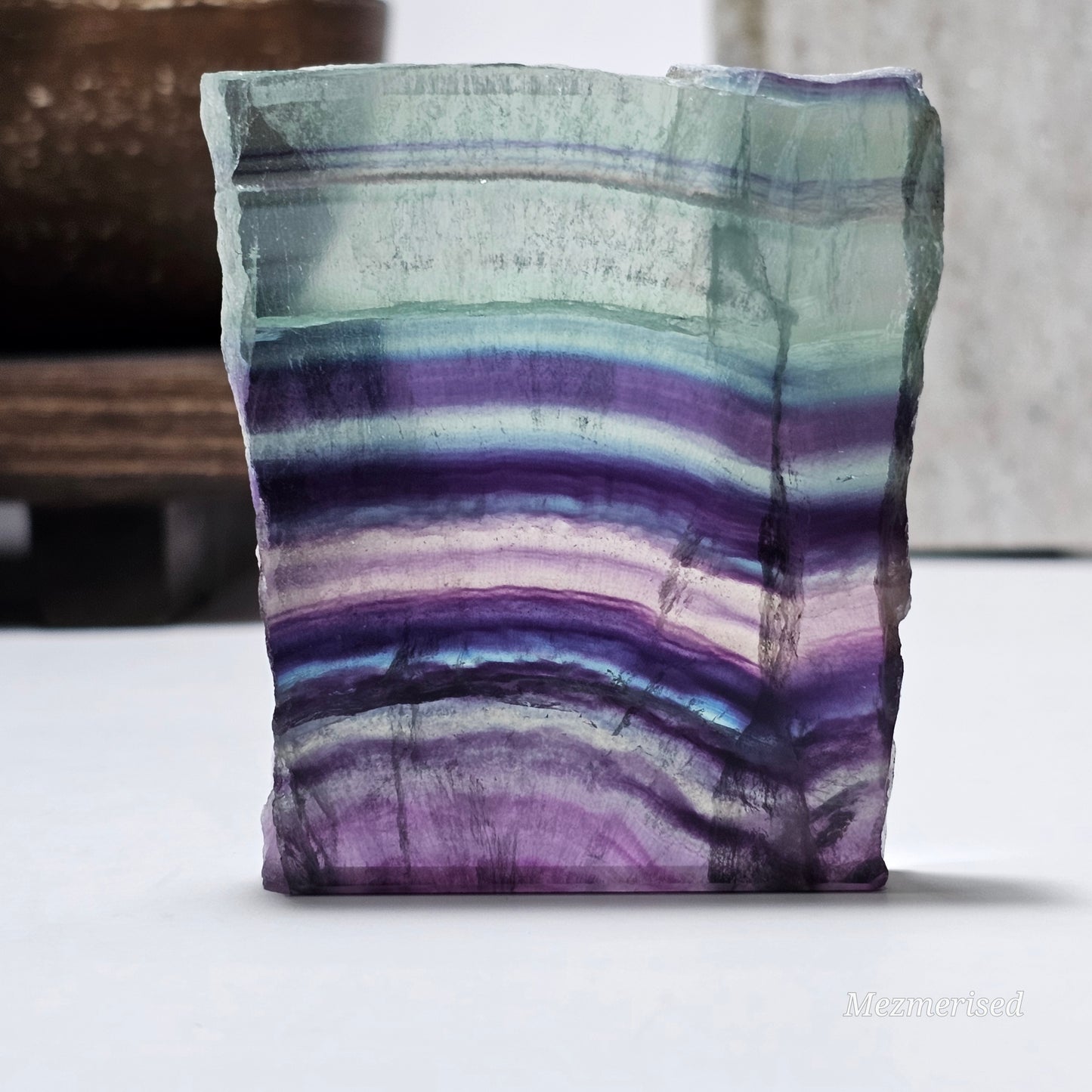 Small Fluorite slab piece standing showing natural form and banding.
