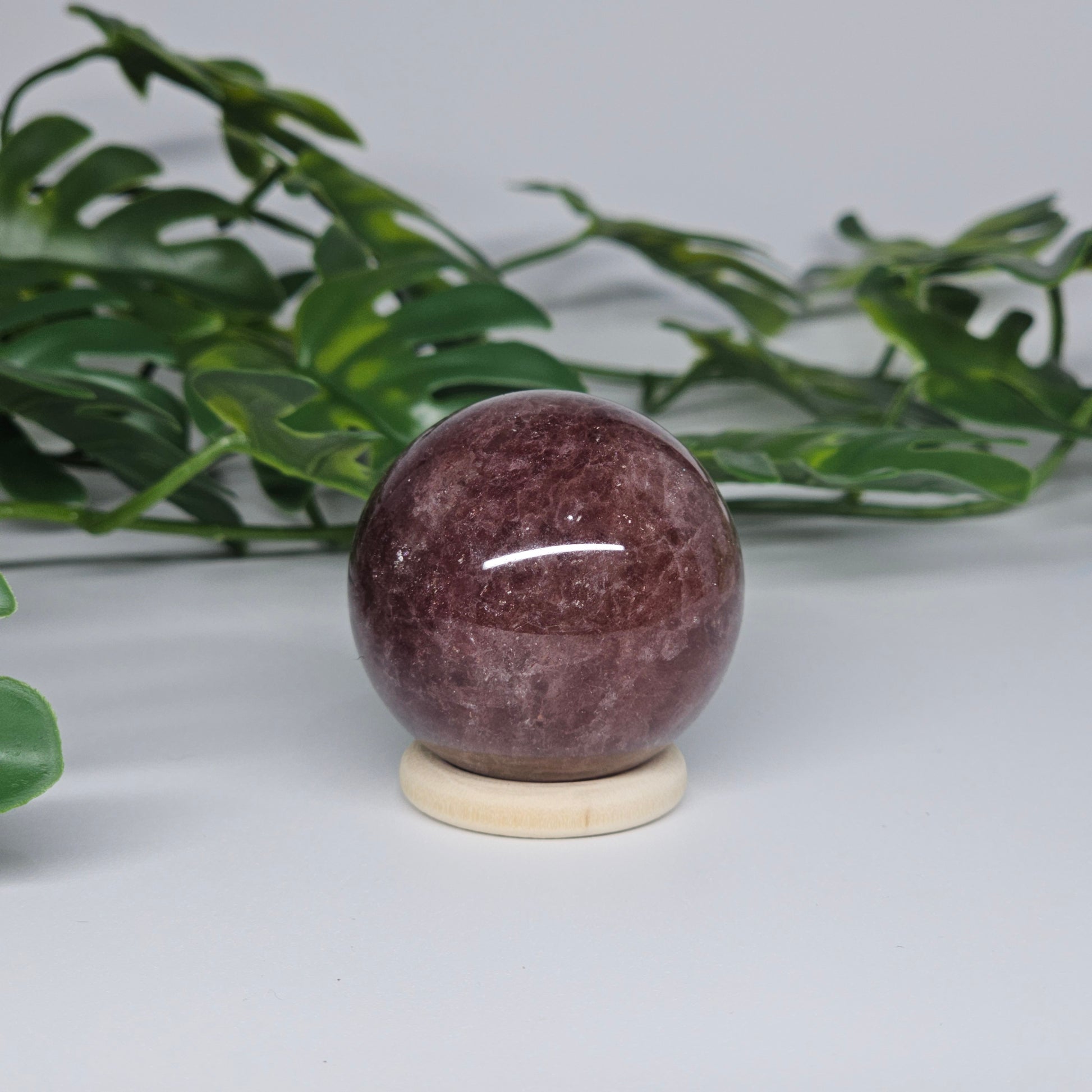Red Aventurine sphere displaying natural shimmer and deep colouring with polished surface detail