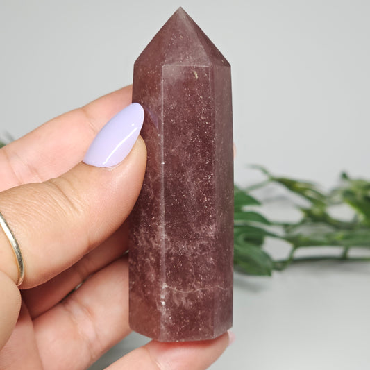 Red Aventurine tower crystal held in hand showing size and natural colour depth