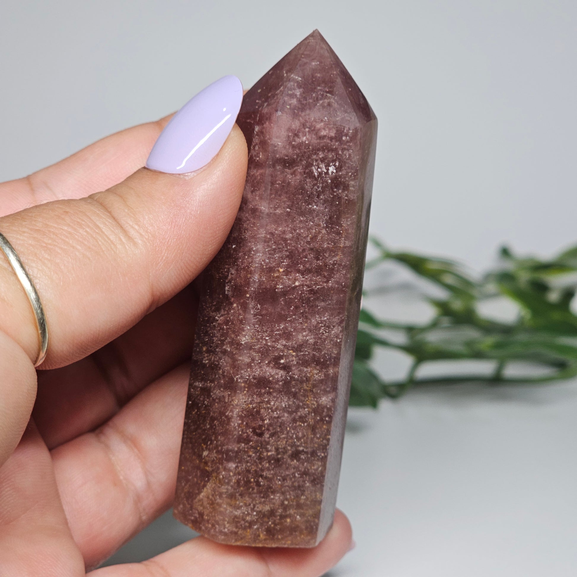 Red Aventurine tower crystal held in hand showing size and natural colour depth