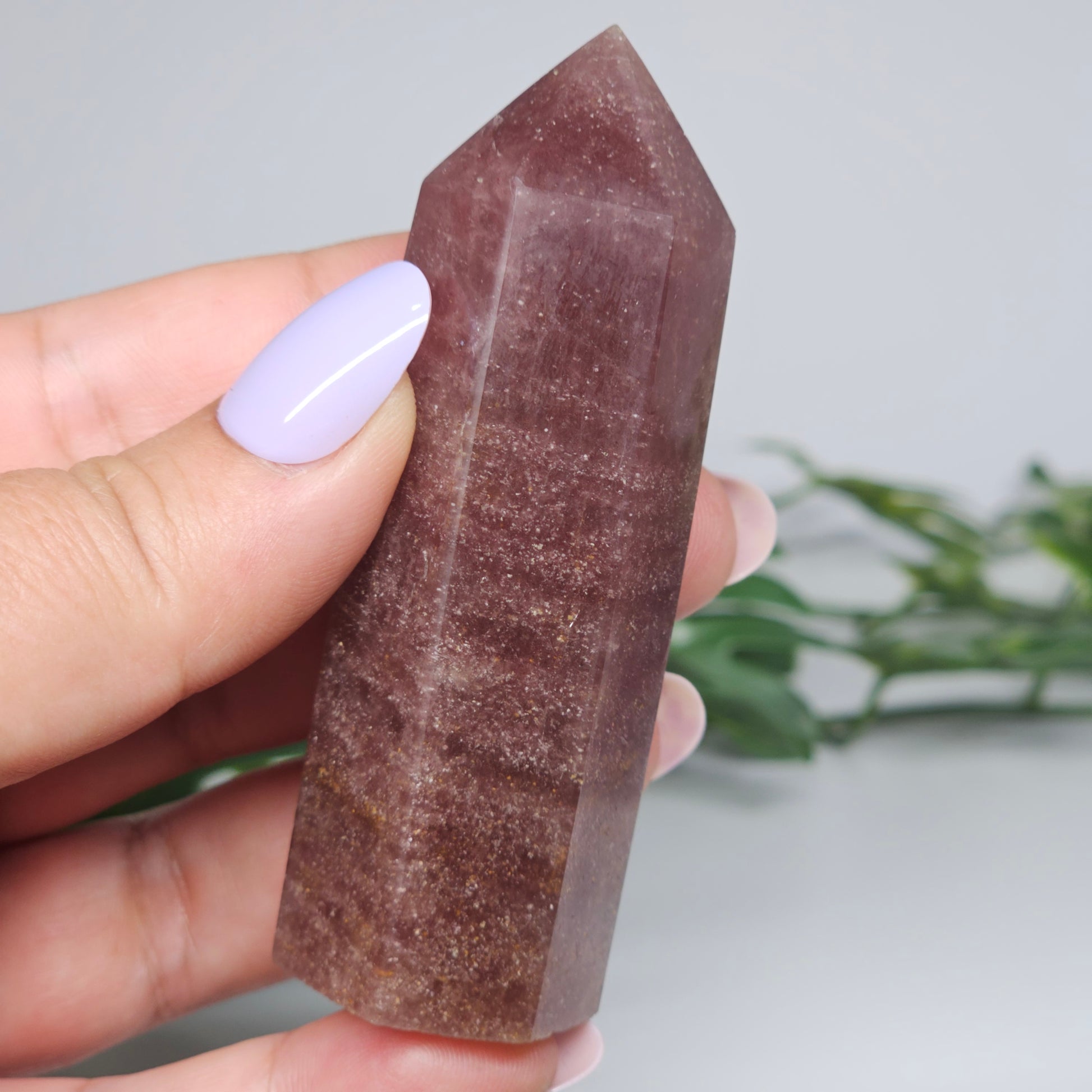 Red Aventurine tower crystal held in hand showing size and natural colour depth