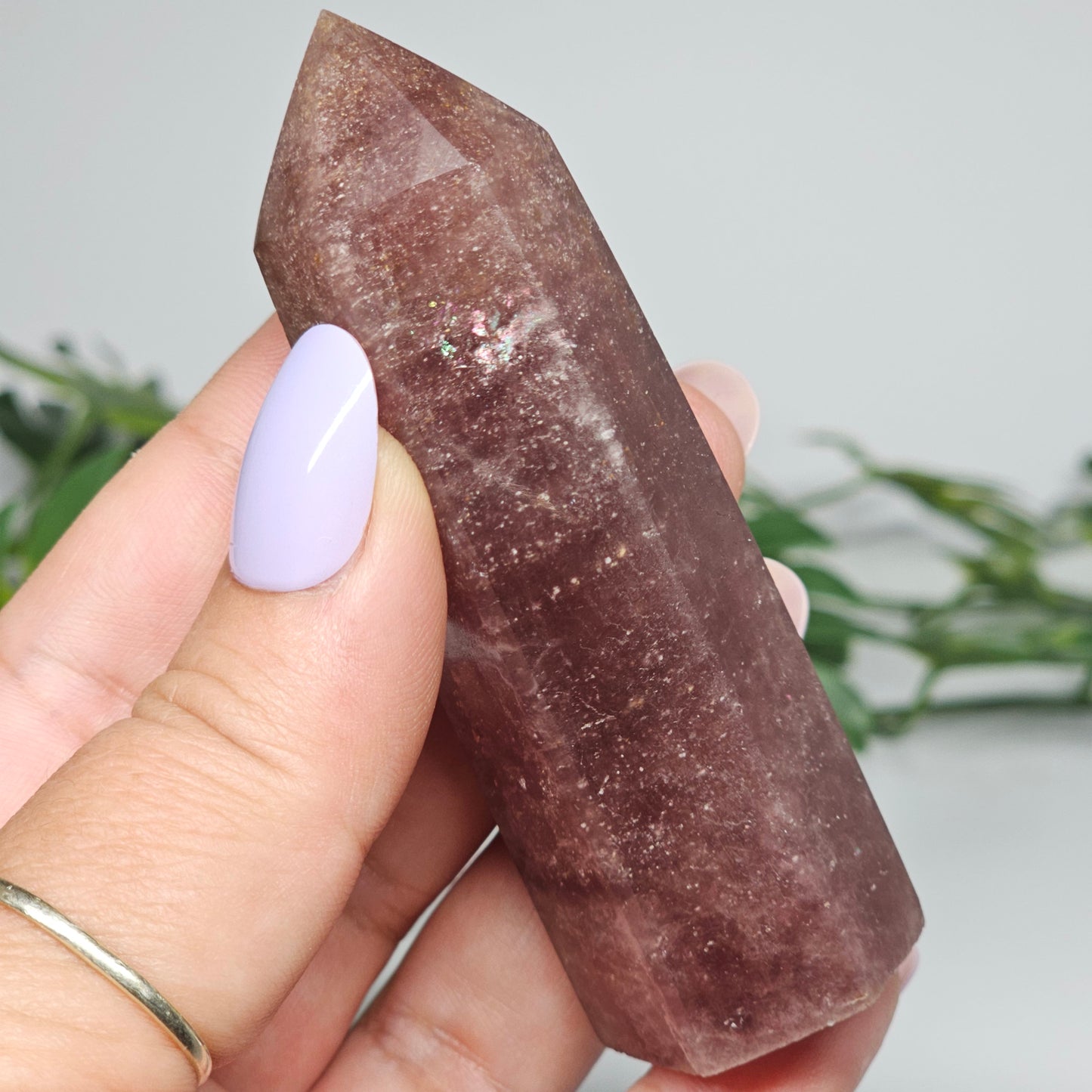 Red Aventurine tower crystal held in hand showing size and natural colour depth