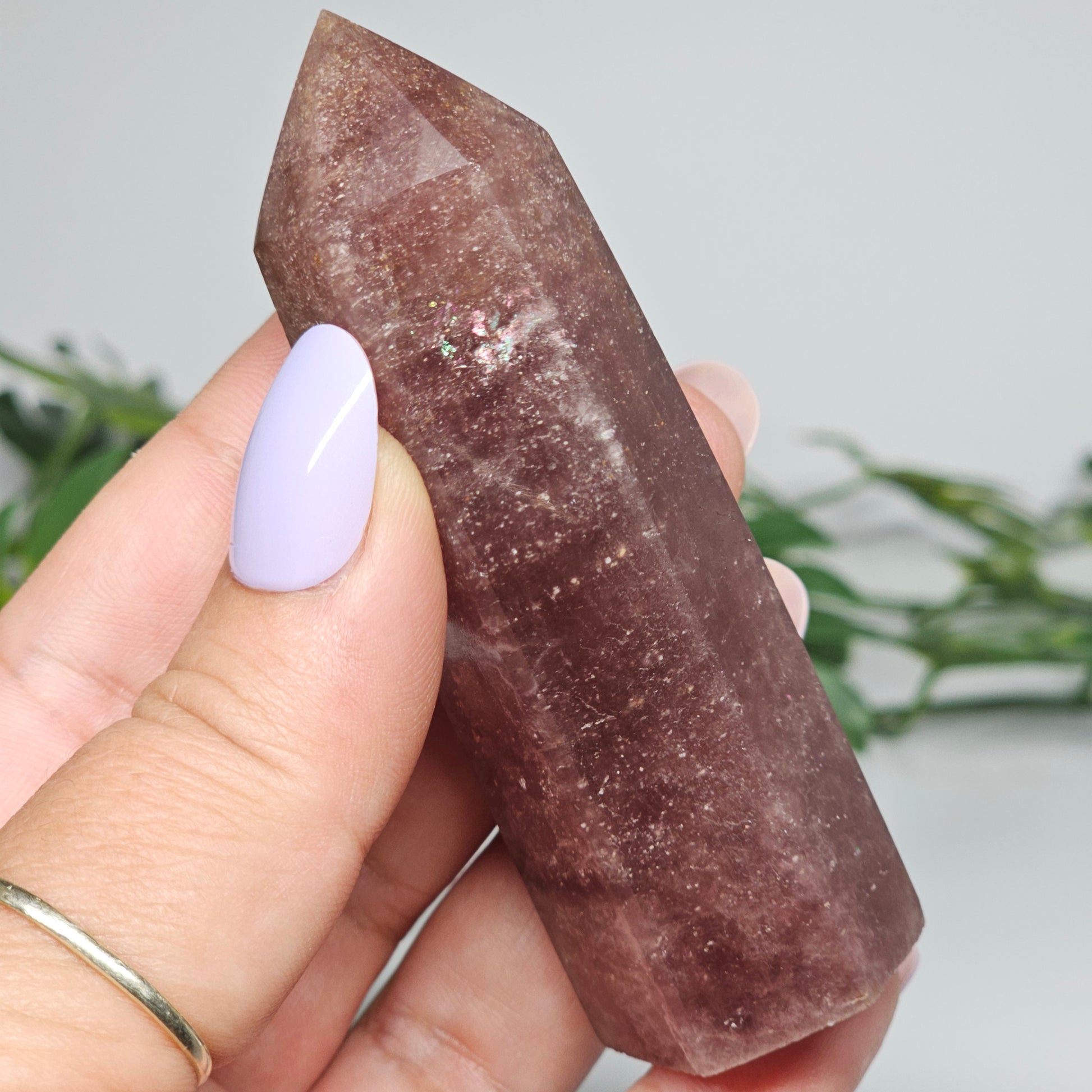 Red Aventurine tower crystal held in hand showing size and natural colour depth