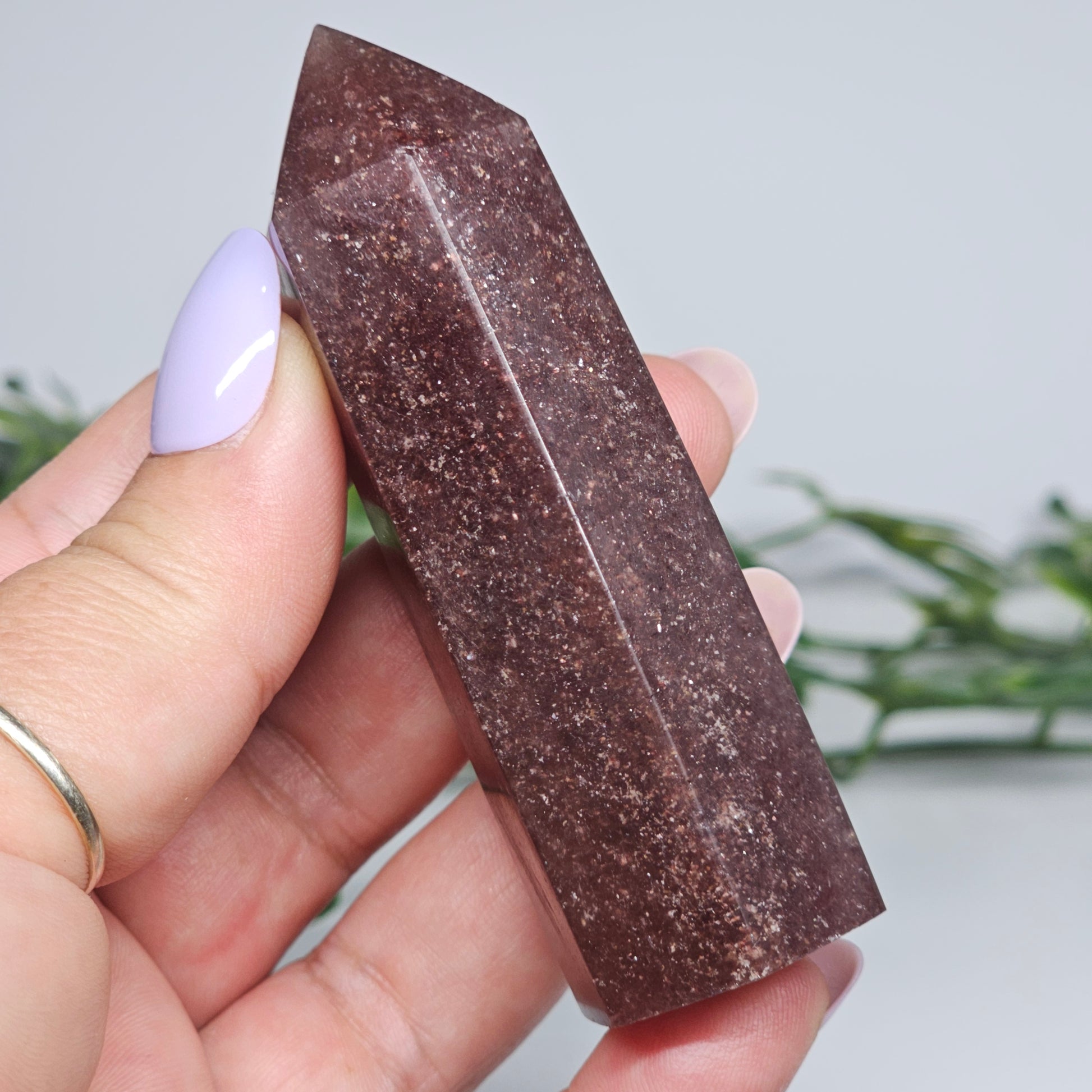 Red Aventurine tower crystal held in hand showing size and natural colour depth