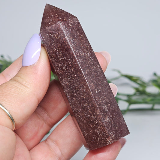 Red Aventurine tower crystal held in hand showing size and natural colour depth