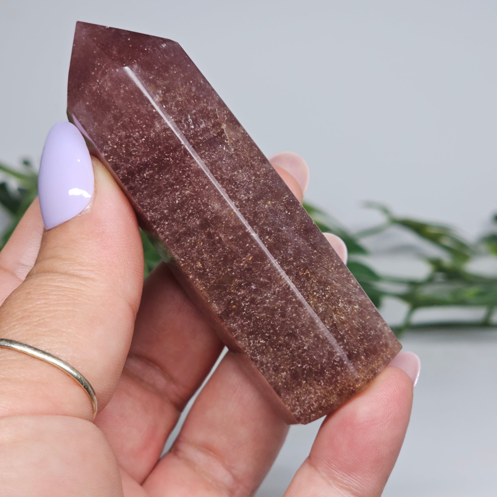 Red Aventurine tower crystal held in hand showing size and natural colour depth