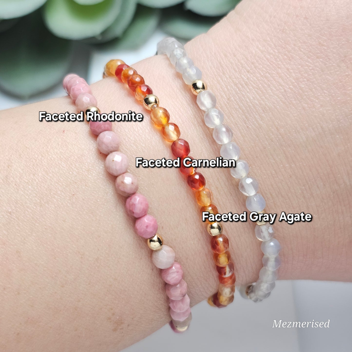 Stacked 4mm Rhodonite, Carnelian and Gray Agate gemstone bracelets with minimalist gold accent details.