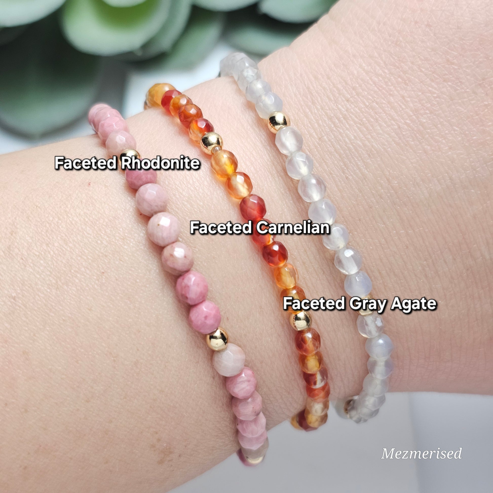 Stacked 4mm Rhodonite, Carnelian and Gray Agate gemstone bracelets with minimalist gold accent details.