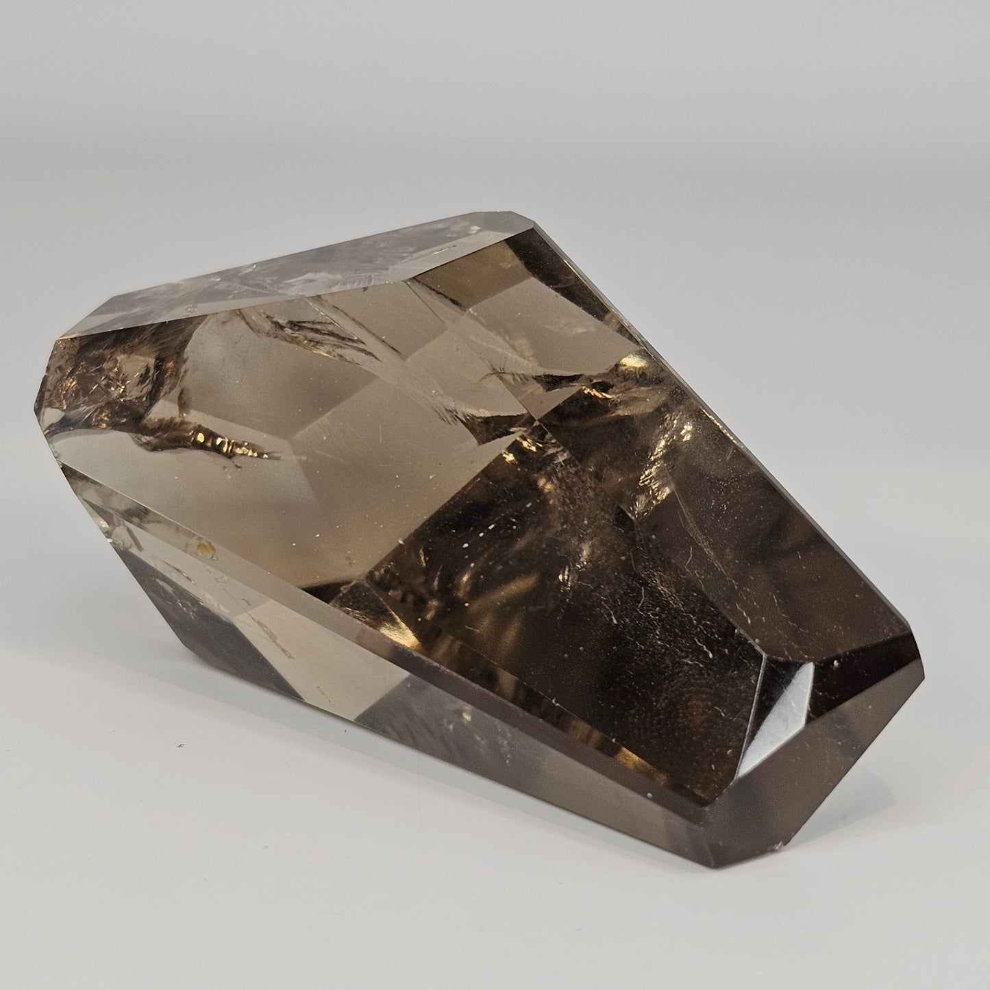 Side profile of the Smoky Citrine freeform highlighting its clarity, depth, and smooth polished formation with smoky golden gradients.