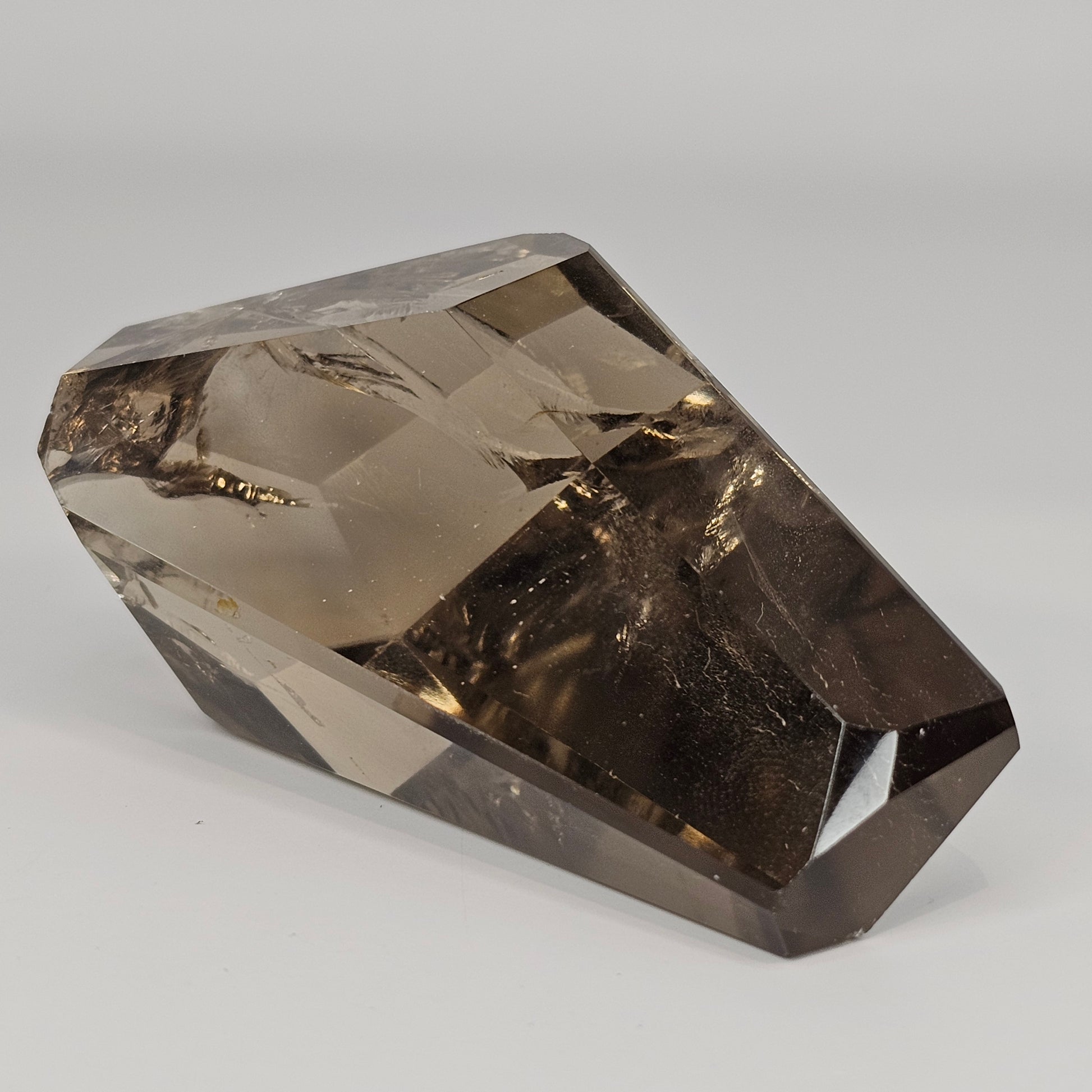 Side profile of the Smoky Citrine freeform highlighting its clarity, depth, and smooth polished formation with smoky golden gradients.