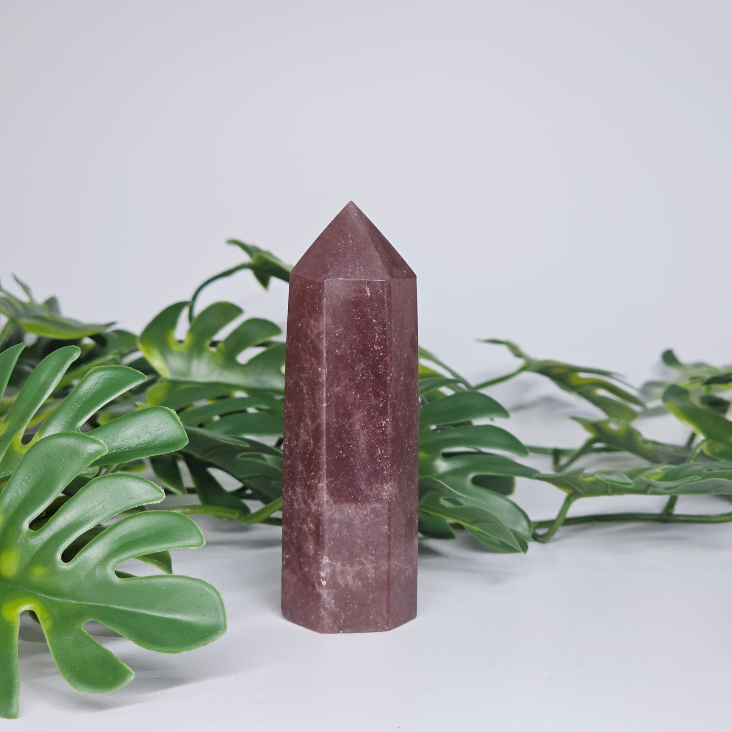 Strawberry quartz crystal tower with deep pink red tones and natural shimmering inclusions