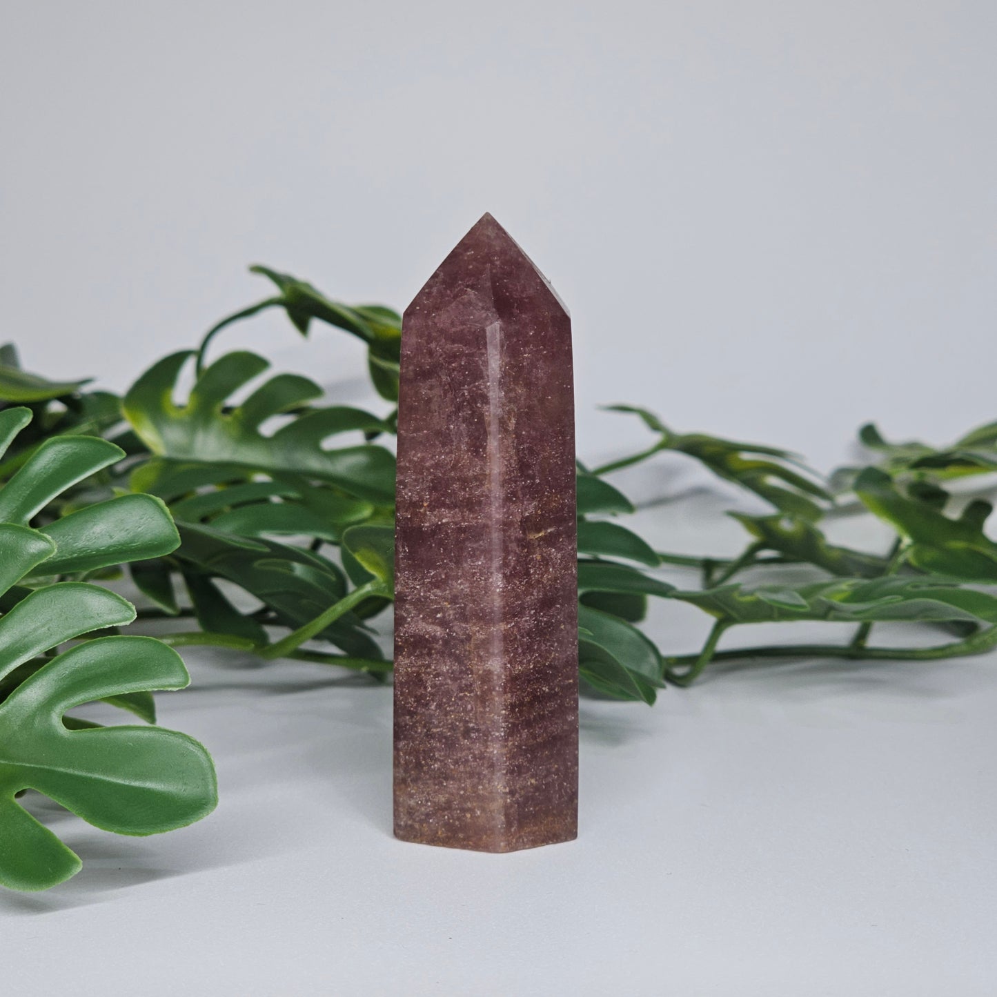 Strawberry quartz crystal tower with deep pink red tones and natural shimmering inclusions