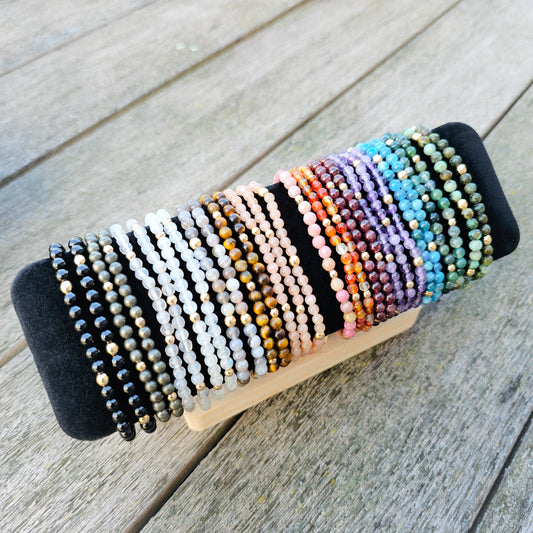 Various 4mm bracelet featuring natural gemstone beads with gold accent details.