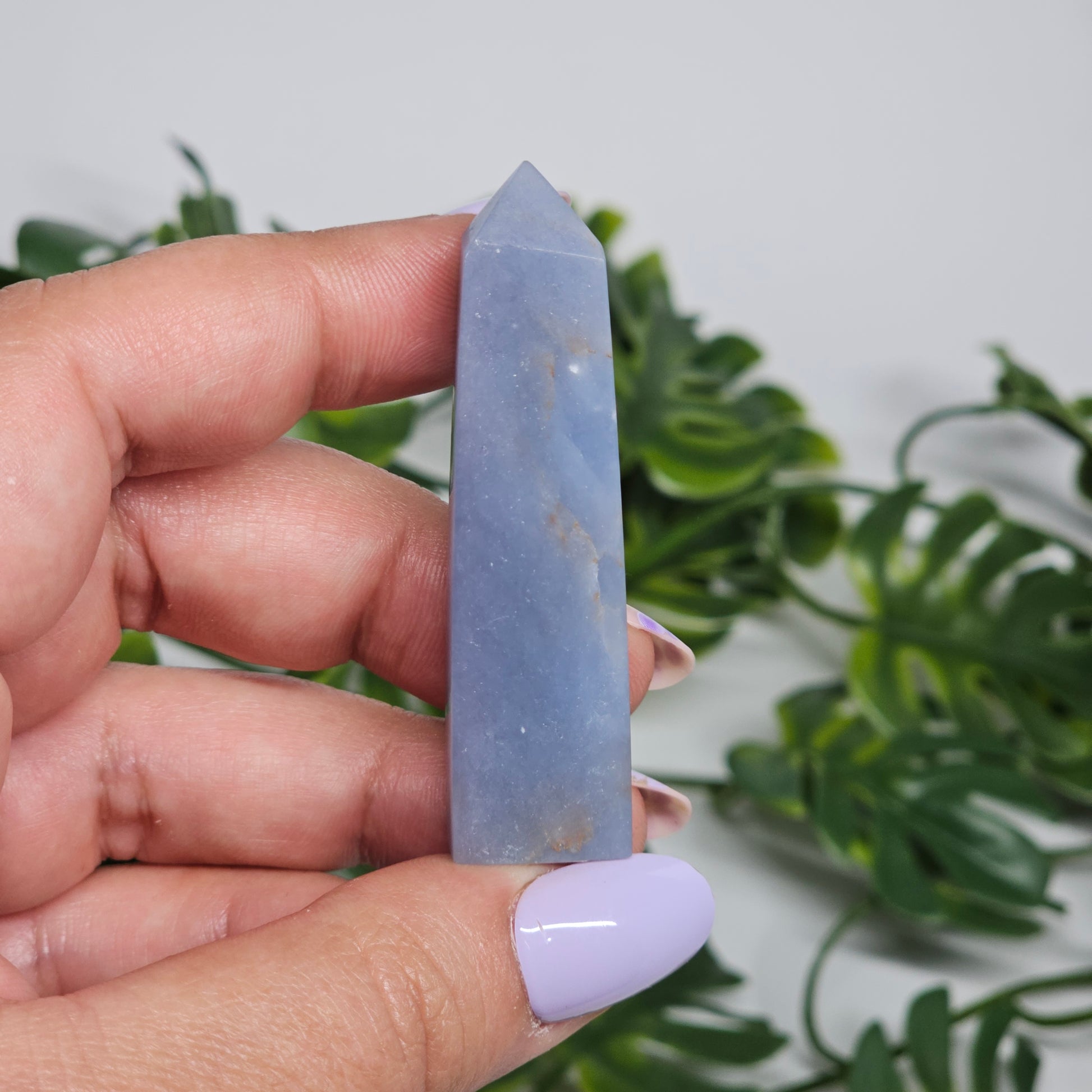 blue Angelite tower close up in hand