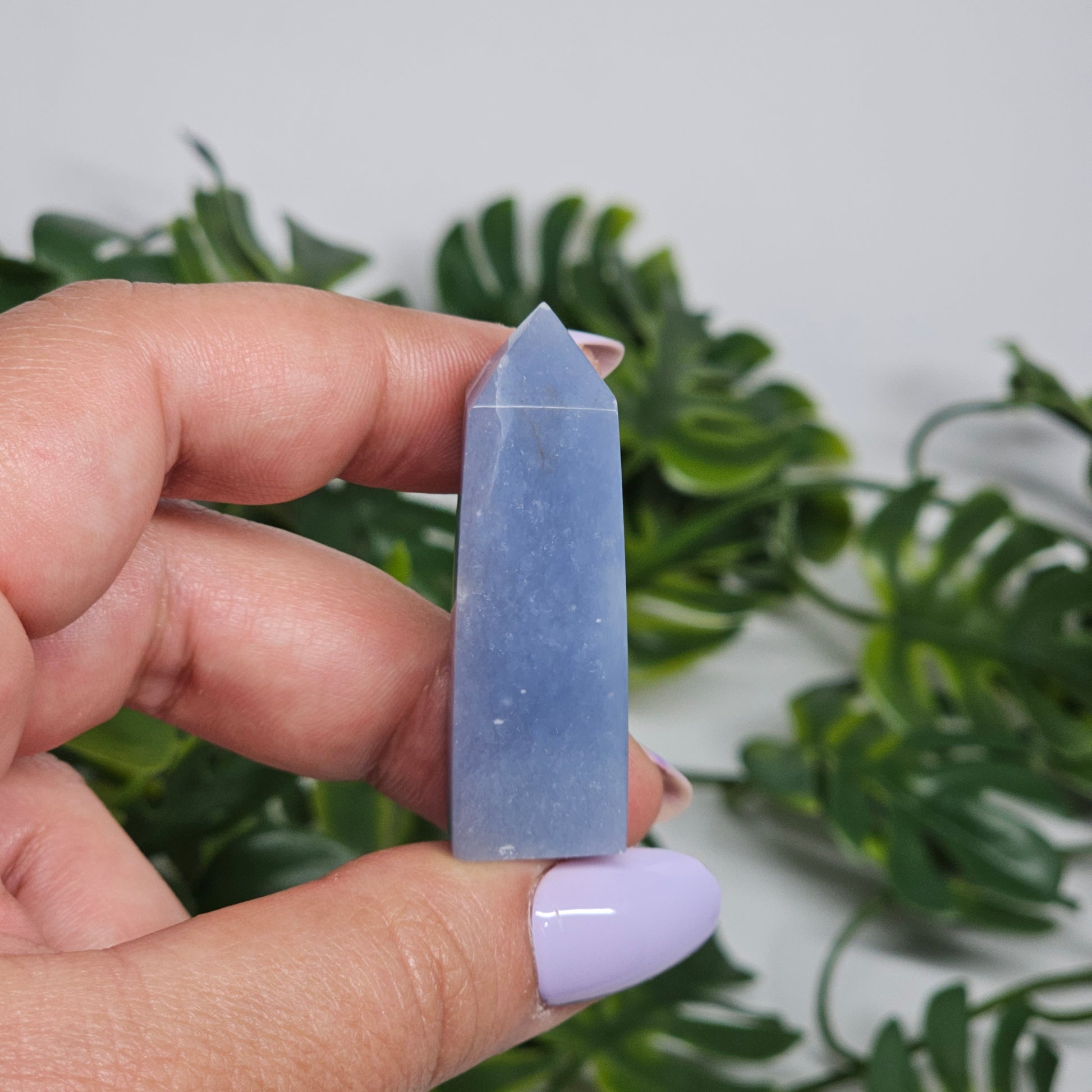 blue Angelite tower close up in hand