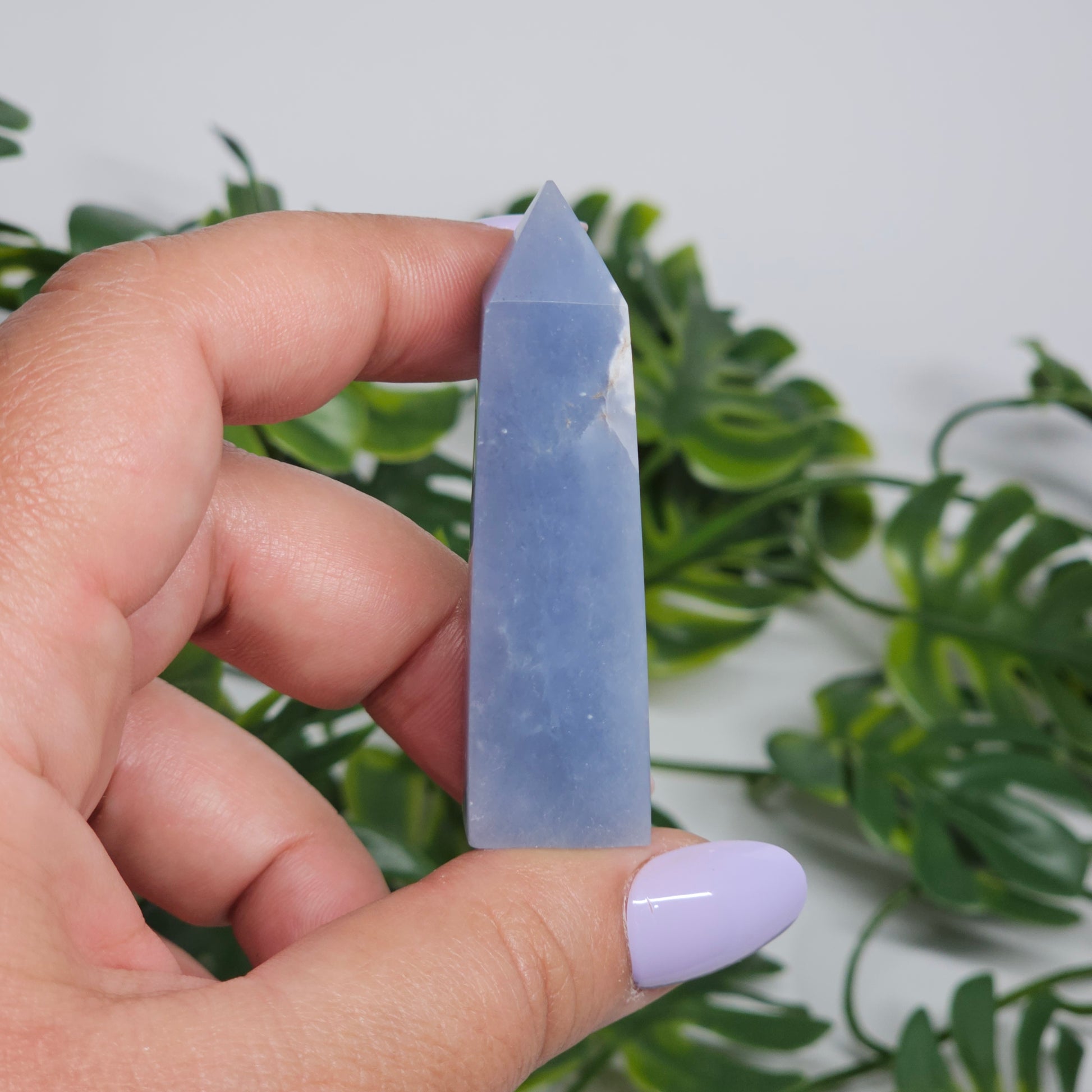 blue Angelite tower close up in hand