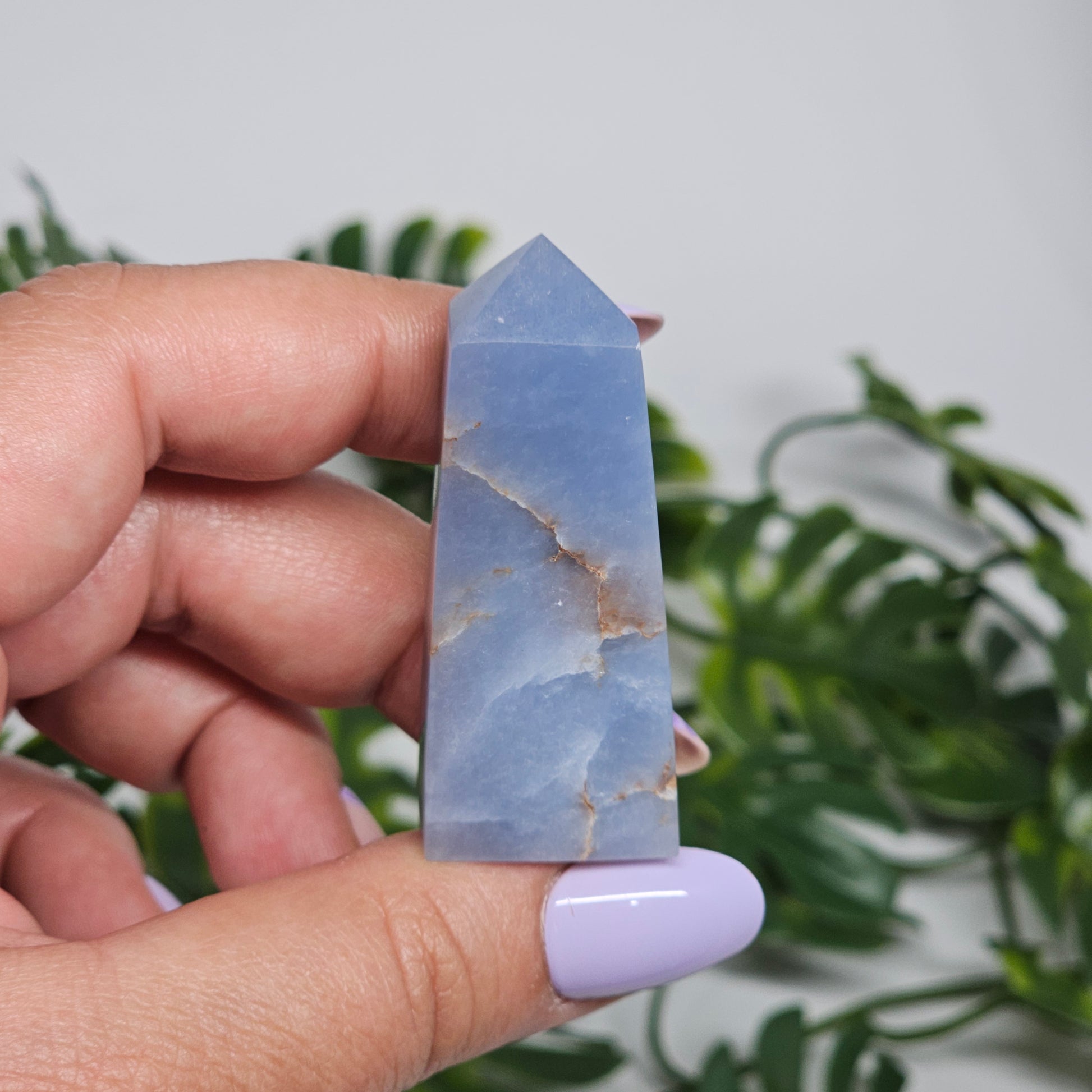 blue Angelite tower close up in hand