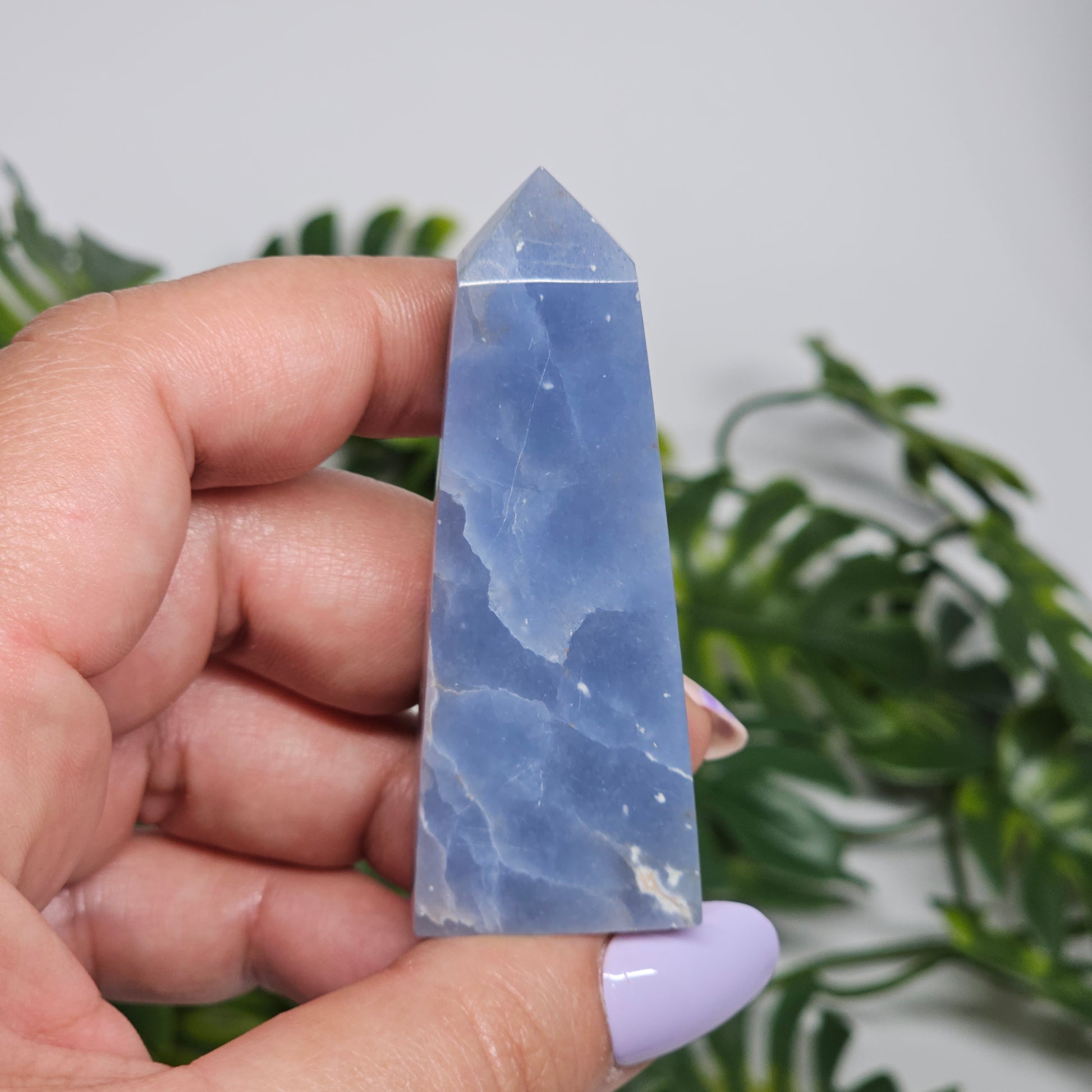 blue Angelite tower close up in hand