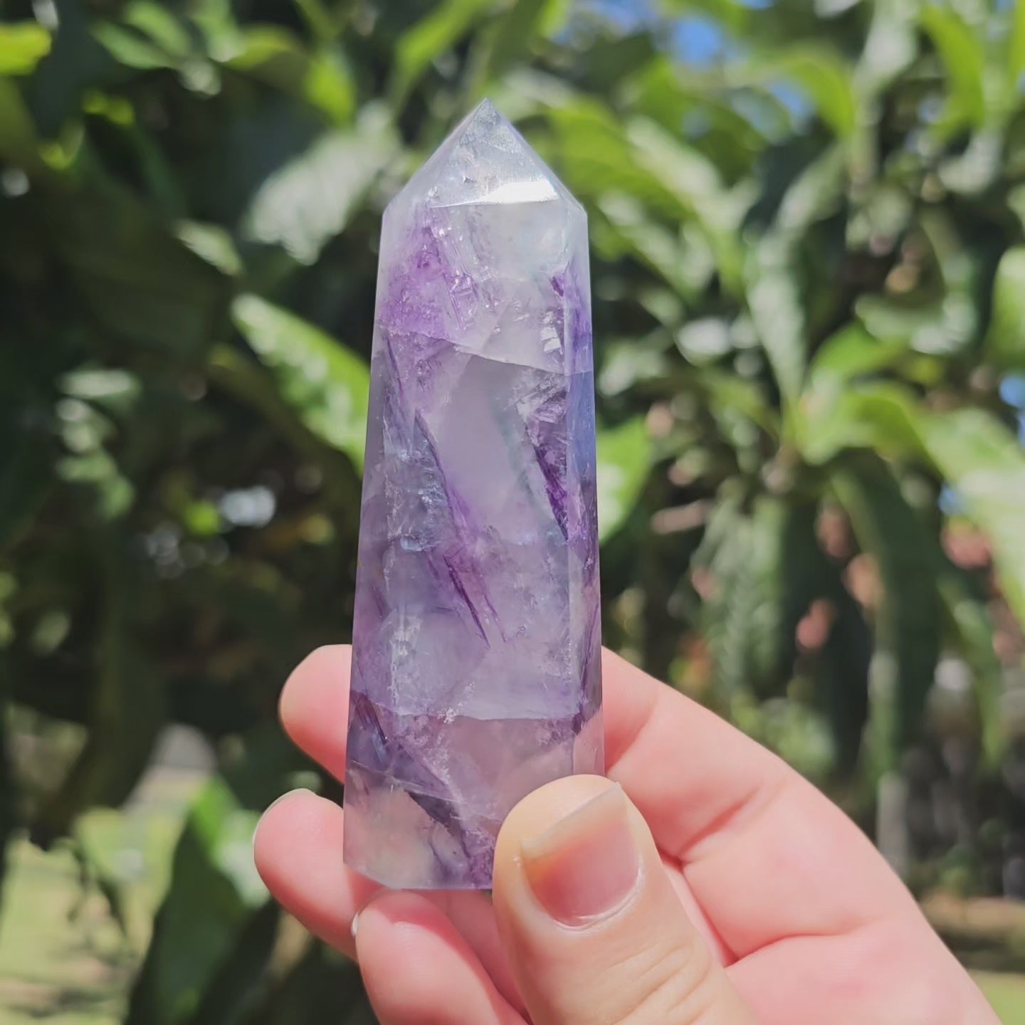 Spectacular clear Fluorite tower with vibrant purple, pastel blue &amp; pastel green banding. Also has beautiful rainbows throughout.