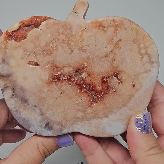 A video walkthrough rotating the Pink Amethyst apple to display all polished sides and sparkling druzy.