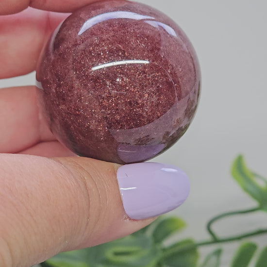 Strawberry Quartz sphere video showing full 360 degree rotation highlighting shimmer, deep colour and polished finish