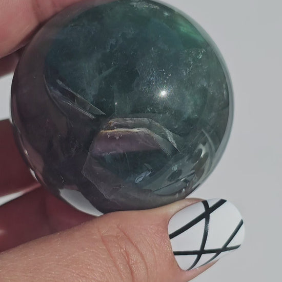 Rich dark forest green Fluorite sphere with beautiful rainbows