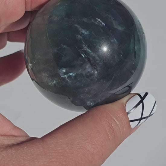 Rich dark forest green Fluorite sphere with beautiful rainbows