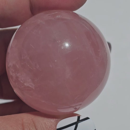 A beautiful Rose Quartz sphere with asterism and gorgeous rainbows