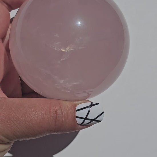 A beautiful Rose Quartz sphere with flash and gorgeous rainbows