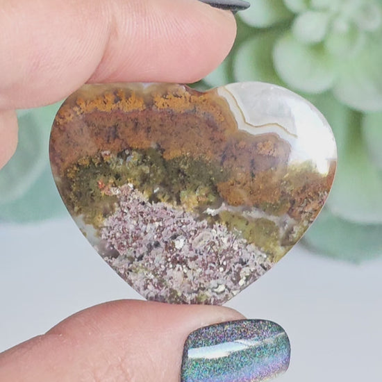 An exquisite heart carving, showcasing the alluring uniqueness of the Scenic Moss Agate which resembles nature's beautiful landscapes.