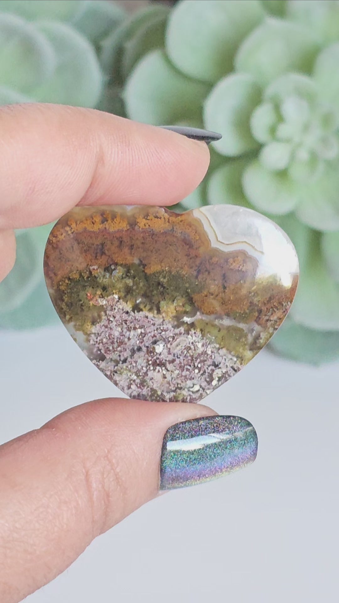 An exquisite heart carving, showcasing the alluring uniqueness of the Scenic Moss Agate which resembles nature's beautiful landscapes.