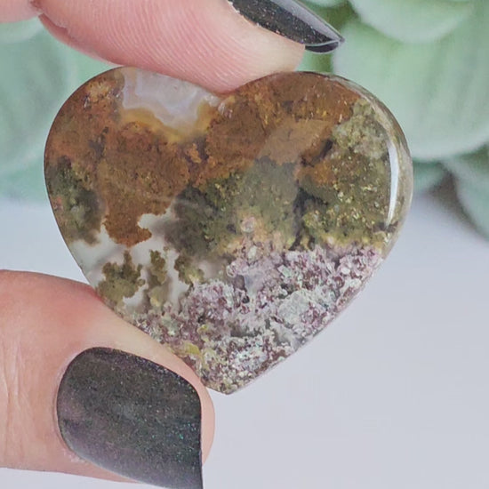 An exquisite heart carving, showcasing the alluring uniqueness of the Scenic Moss Agate which resembles nature's beautiful landscapes.