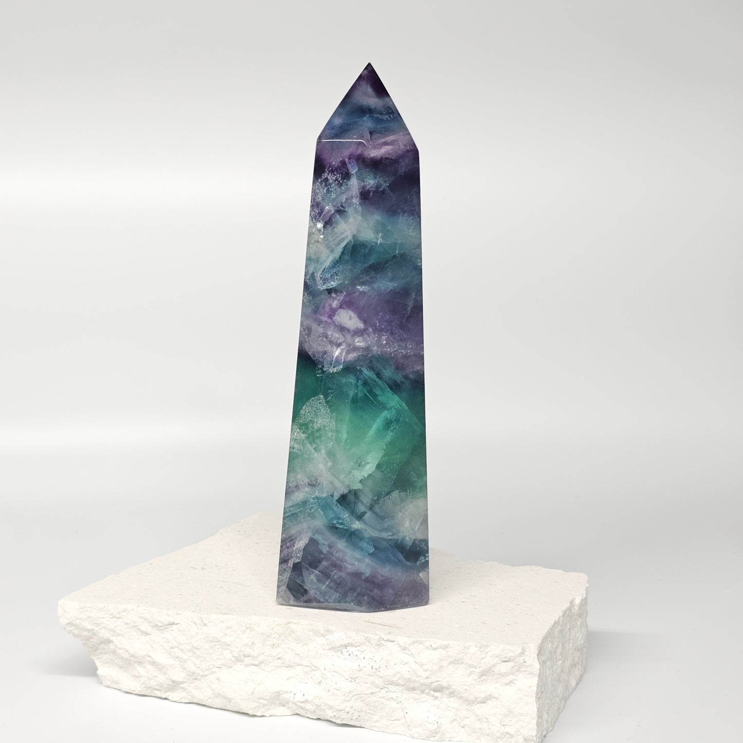 Single large fluorite point crystal tower with purple green blue colour variation