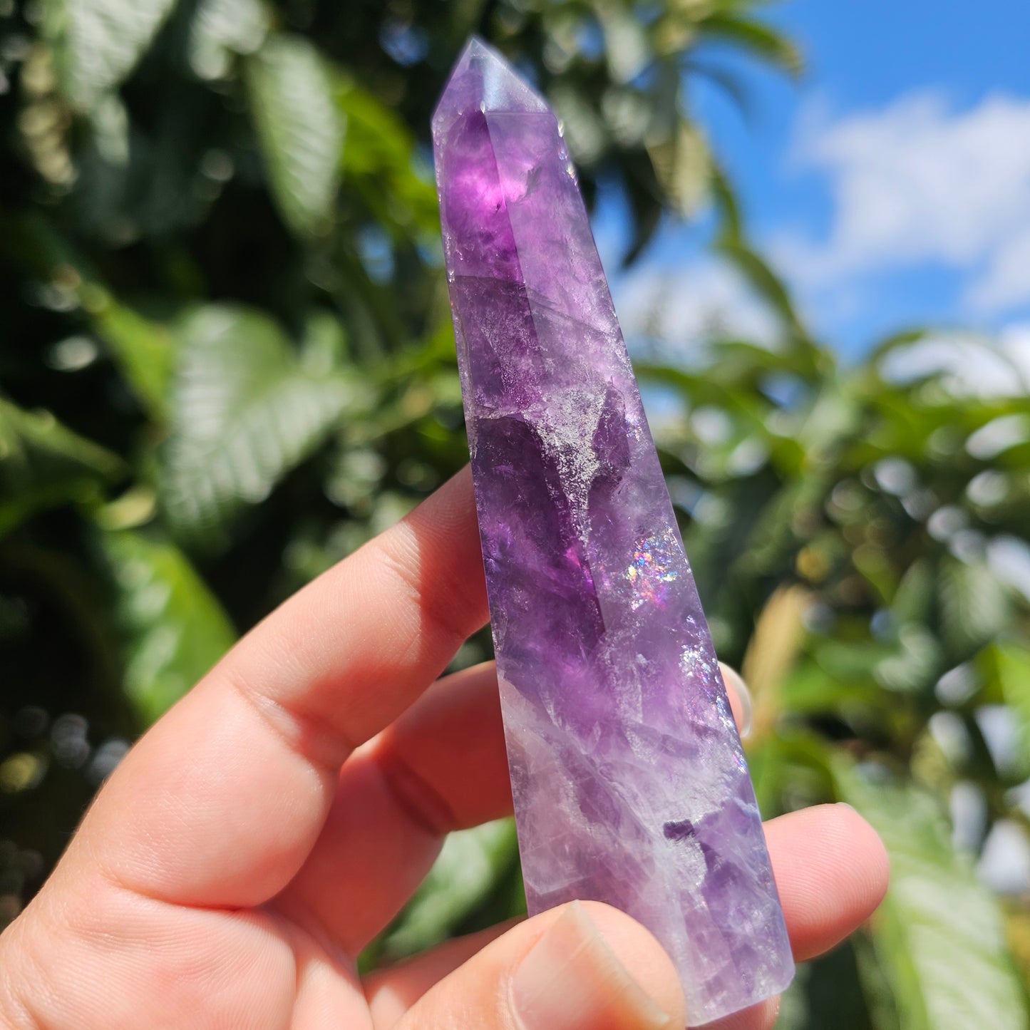 Gorgeous rainbow Fluorite tower with deep purple, blue and green banding. Also has stunning rainbows throughout.