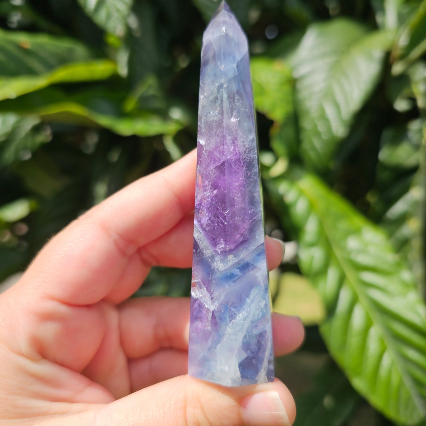 Gorgeous rainbow Fluorite tower with deep purple, blue and green banding. Also has stunning rainbows throughout.