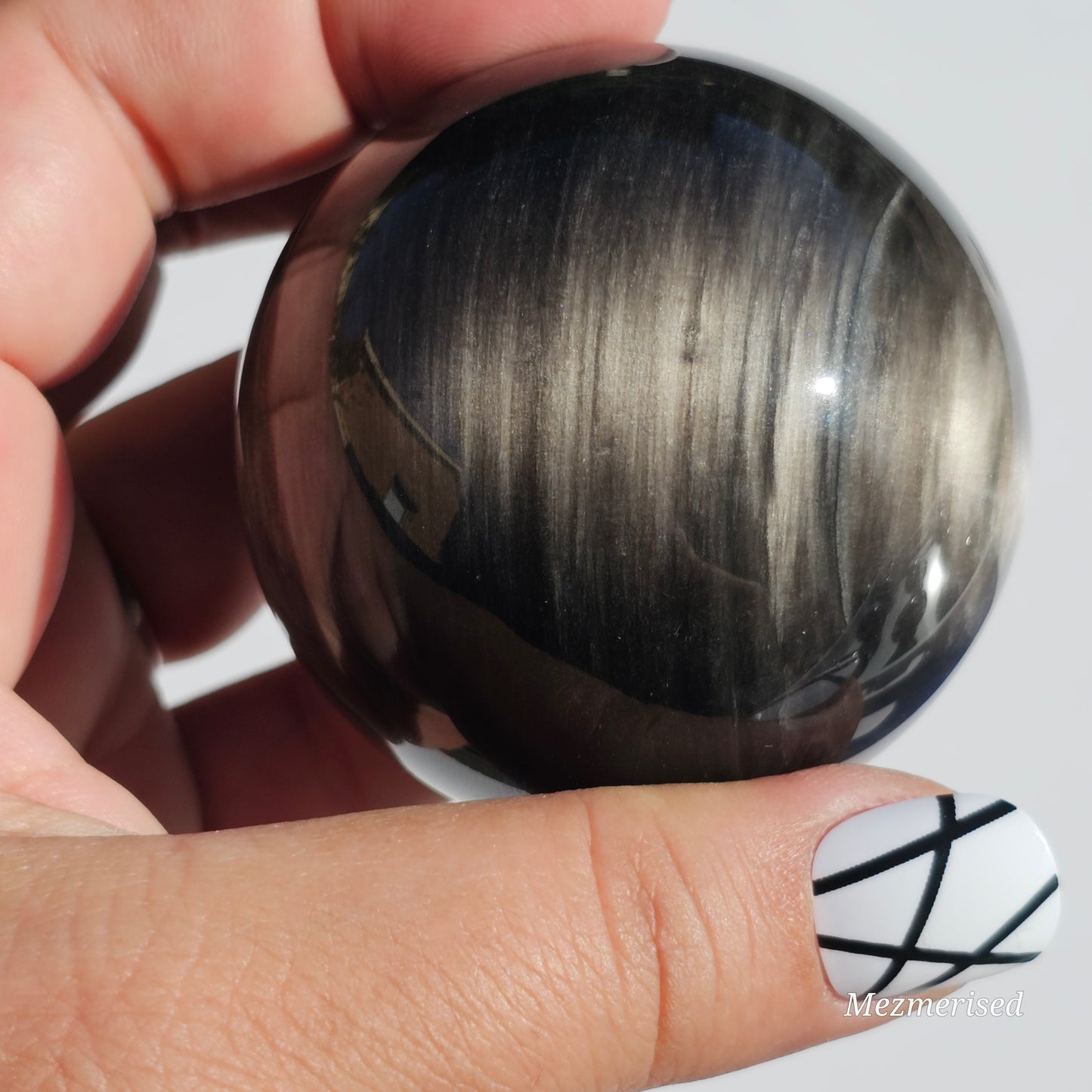 Black Obsidian sphere with an alluring sheen of Silver.