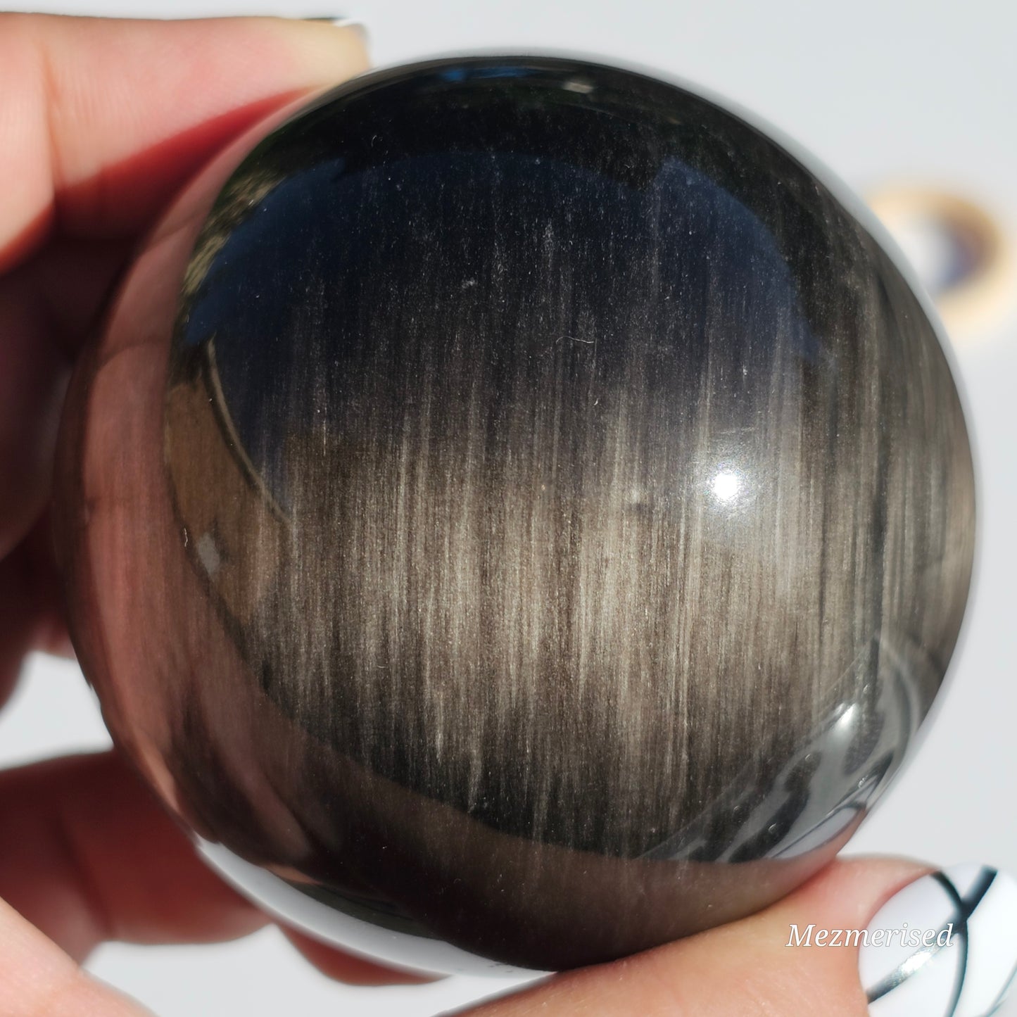 Black Obsidian sphere with an alluring sheen of Silver.