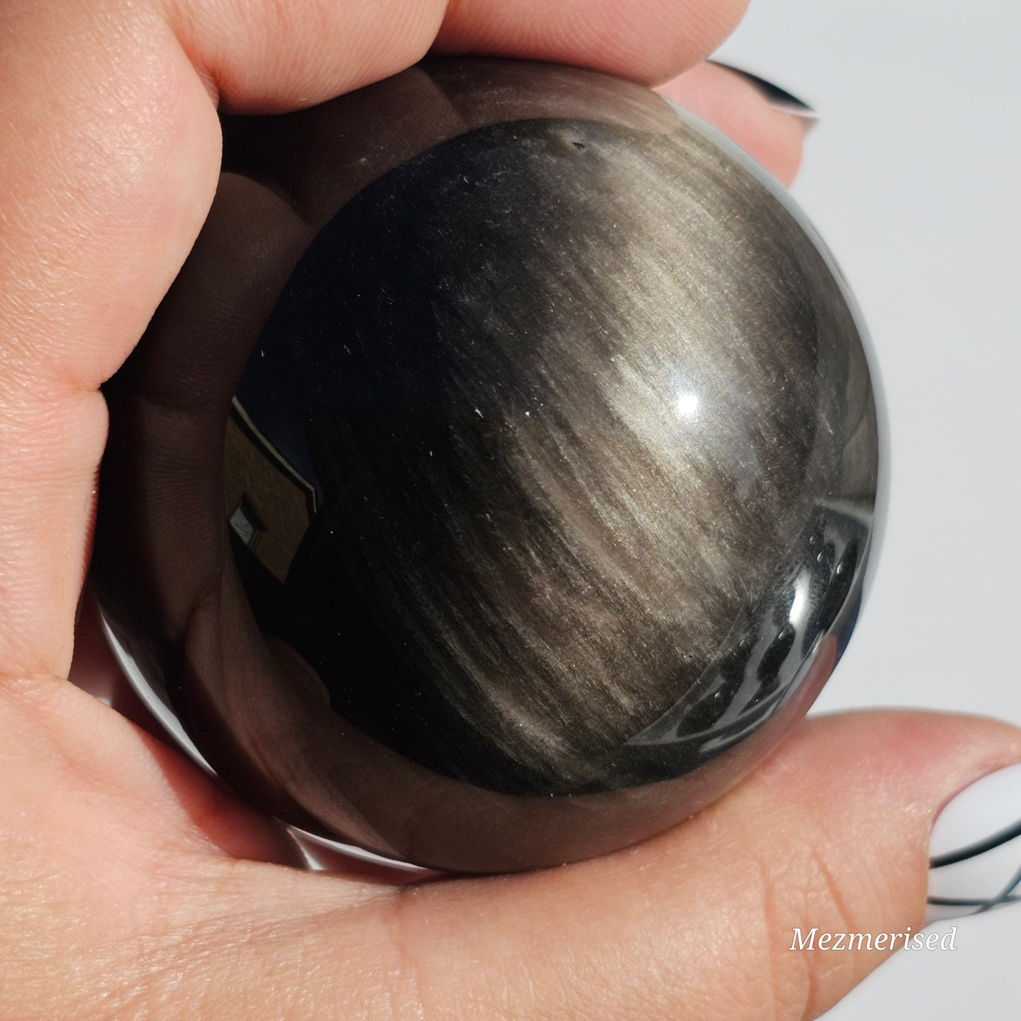 Black Obsidian sphere with an alluring sheen of Silver.