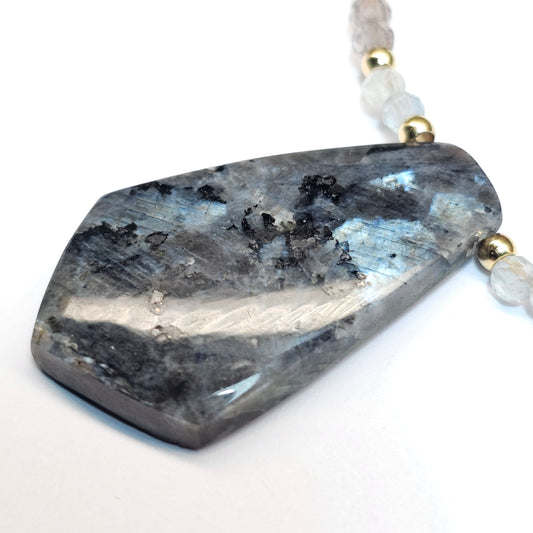 Lunar bloom is a focal Larvikite pendant necklace adorned with Smoky Quartz and Aquamarine beads.