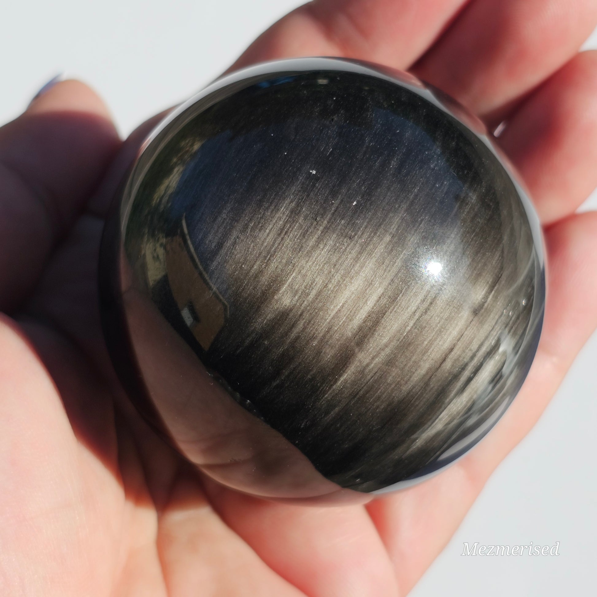 Black Obsidian sphere with an alluring sheen of Silver.