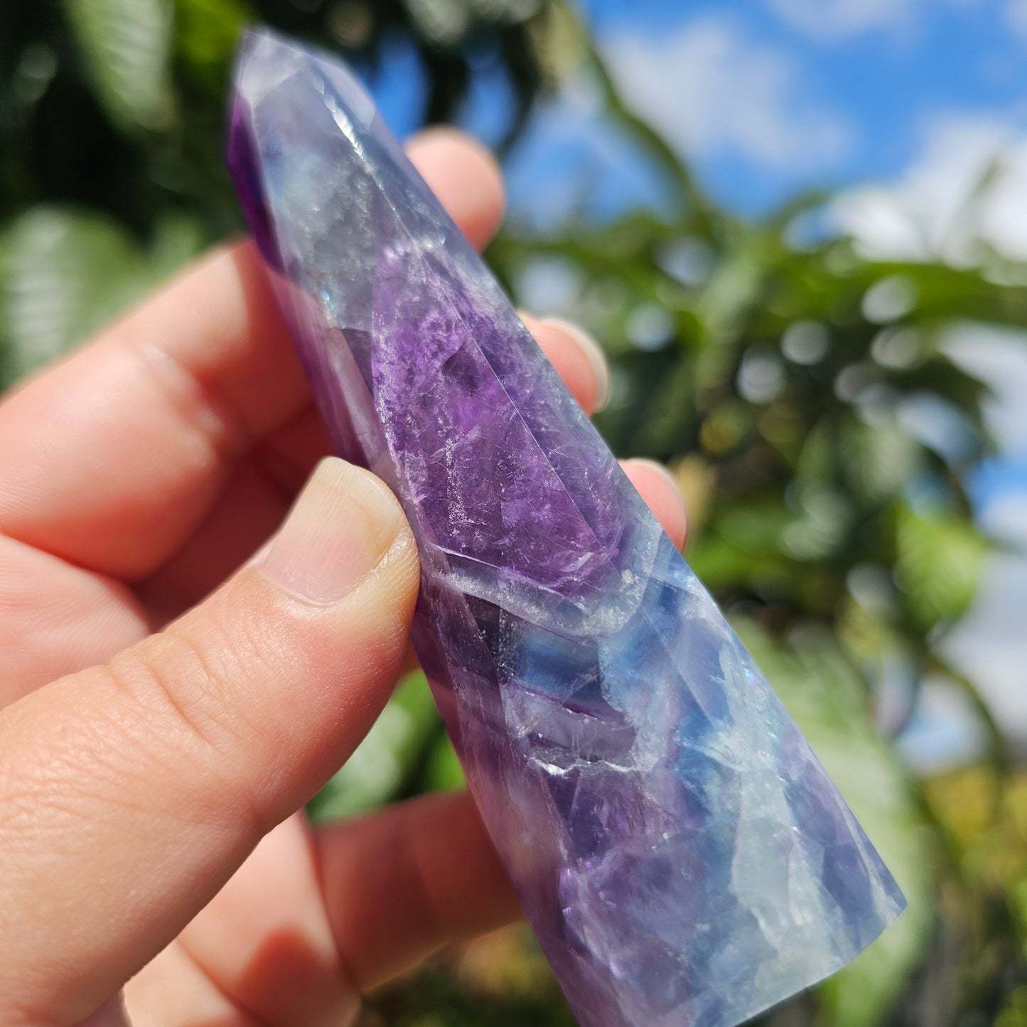 Gorgeous rainbow Fluorite tower with deep purple, blue and green banding. Also has stunning rainbows throughout.