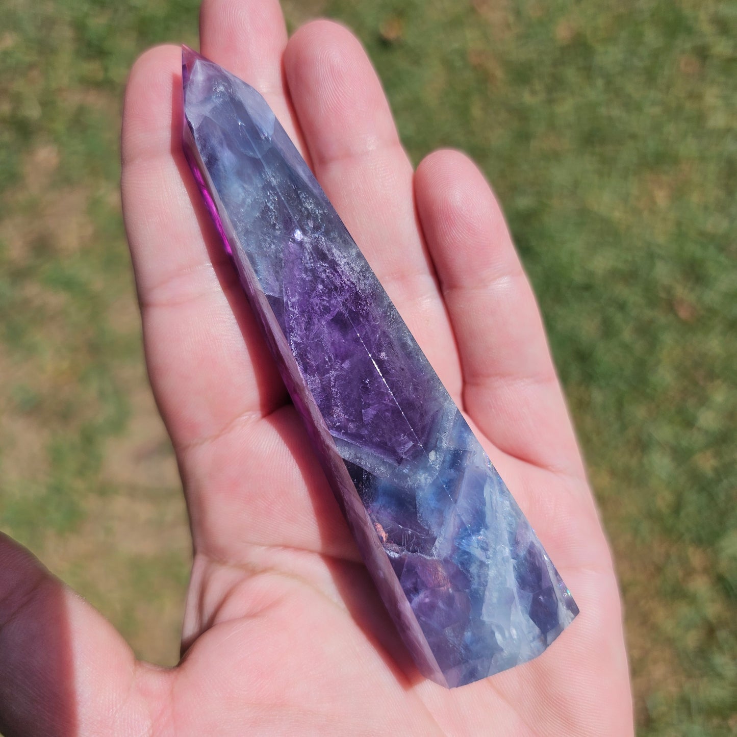 Gorgeous rainbow Fluorite tower with deep purple, blue and green banding. Also has stunning rainbows throughout.