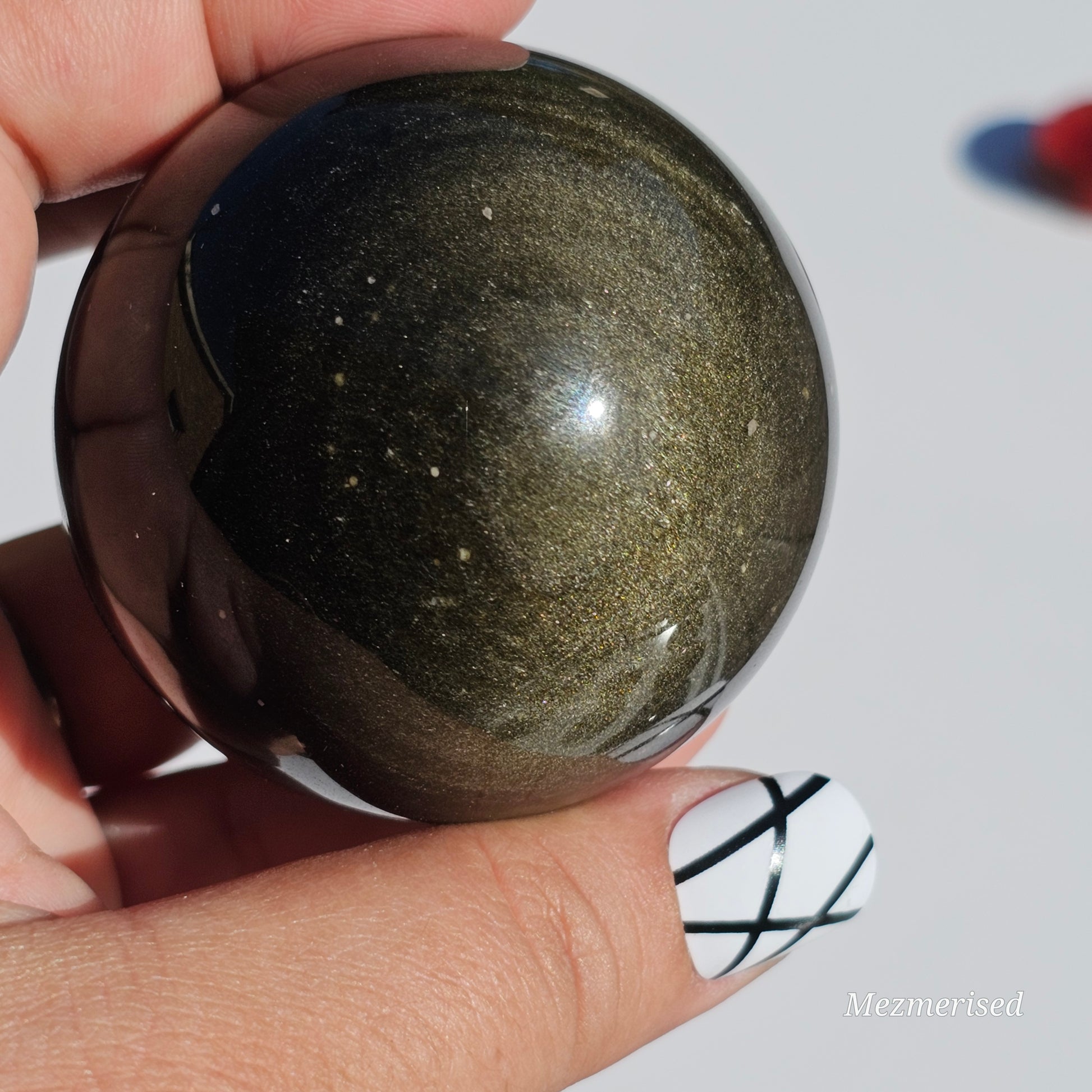 Black Obsidian sphere with an alluring sheen of Gold.